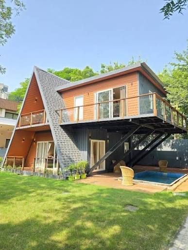 Contemporary A-frame luxury villa with pool built by J. K. Builders & Investors